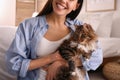 Beautiful young woman with her cute cat in bedroom. Fluffy pet Royalty Free Stock Photo