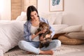 Beautiful young woman with her cute cat on floor in bedroom Royalty Free Stock Photo