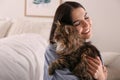 Beautiful young woman with her cute cat . Fluffy pet Royalty Free Stock Photo