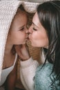 Beautiful young woman with her daughter showing love and affection