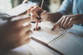 Beautiful young woman and her partner writing something in note pad while sitting on armchair at living room.Charming Royalty Free Stock Photo