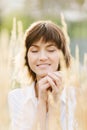 Portrait of a beautiful young girl in a white shirt who smiles with closed eyes Royalty Free Stock Photo