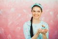 Beautiful young woman holding birthday cupcake and making wish Royalty Free Stock Photo