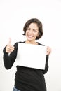 Beautiful young woman holding a blank sheet of paper