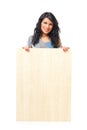 Beautiful young woman holding a blank wooden board Royalty Free Stock Photo