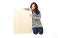 Beautiful young woman holding a blank wooden board Royalty Free Stock Photo