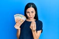 Beautiful young woman holding bunch of 50 euro banknotes doing money gesture with hands, asking for salary payment, millionaire Royalty Free Stock Photo