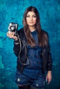 Beautiful young woman holding camera