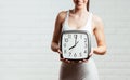 Beautiful, young woman holding a clock close up Royalty Free Stock Photo