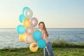 Beautiful young woman holding colorful balloons Royalty Free Stock Photo