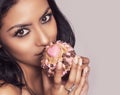 Beautiful young woman holding cup cake with heart