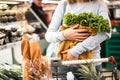 Young woman holding eco bag with greenery. Royalty Free Stock Photo