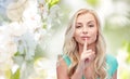 Beautiful young woman holding finger at her lips Royalty Free Stock Photo