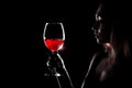 Beautiful young woman holding the glass of a red wine Royalty Free Stock Photo