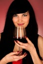 Beautiful young woman holding a glass of red wine Royalty Free Stock Photo