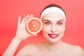 Beautiful young woman holding grapefruit Royalty Free Stock Photo
