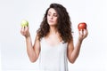 Beautiful young woman holding green and red apples over white background. Royalty Free Stock Photo