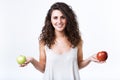 Beautiful young woman holding green and red apples over white background. Royalty Free Stock Photo