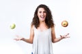 Beautiful young woman holding green and red apples over white background. Royalty Free Stock Photo