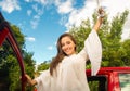 Beautiful young woman holding her keys and smiling near of her red car open Royalty Free Stock Photo