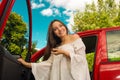 Beautiful young woman holding her keys and smiling near to her own red car Royalty Free Stock Photo