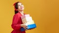 Beautiful young woman holding a lot of boxes with Christmas and New Year`s gifts Royalty Free Stock Photo