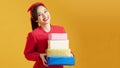 Beautiful young woman holding a lot of boxes with Christmas and New Year`s gifts Royalty Free Stock Photo