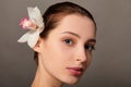 Beautiful young woman holding orchid flower Royalty Free Stock Photo