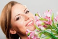 Beautiful young woman holding pink spring flowers Royalty Free Stock Photo