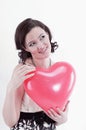 Beautiful young woman holding red balloon heart. Royalty Free Stock Photo