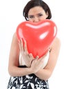 Beautiful young woman holding red balloon heart. Royalty Free Stock Photo