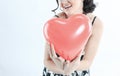 Beautiful young woman holding red balloon heart. Royalty Free Stock Photo