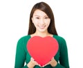 Beautiful young woman holding red heart gift box