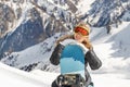 Beautiful young woman holding snowboard, she`s looking at camera and smiling, copy space Royalty Free Stock Photo
