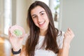 Beautiful young woman holding spicy asian wasabi screaming proud and celebrating victory and success very excited, cheering Royalty Free Stock Photo