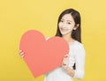 Beautiful young Woman holding Valentines Day red heart sign Royalty Free Stock Photo