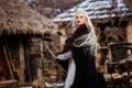 Beautiful young woman holding a viking with blond hair. Image of Historical figure Royalty Free Stock Photo