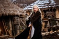 Beautiful young woman holding a viking with blond hair. Image of Historical figure