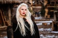 Beautiful young woman holding a viking with blond hair. Image of Historical figure