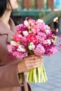 Beautiful young woman holding bridal bouquet in pink lilac tones made of hyacinth, tulips and gypsophila Royalty Free Stock Photo