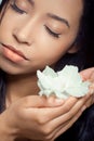 Beautiful young woman holding a white flower Royalty Free Stock Photo