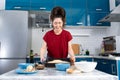 A beautiful young woman holds a baking tray with pizza dough. The concept of home cooking and slow food Royalty Free Stock Photo