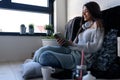 Beautiful young woman at home drinking coffee reading a book Royalty Free Stock Photo