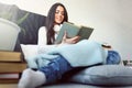 Beautiful young woman at home drinking coffee reading a book Royalty Free Stock Photo