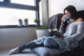 Beautiful young woman at home drinking coffee reading a book Royalty Free Stock Photo