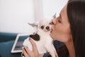 Beautiful young woman at home with her dog