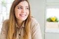 Beautiful young woman at home smiling looking side and staring away thinking Royalty Free Stock Photo