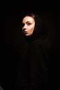 Beautiful young woman in Hood. hipster girl in dark weared Hoodie