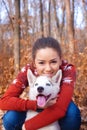 Beautiful young woman hugging huskies puppy for a walk in the park