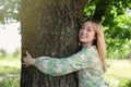 Beautiful young woman hugging tree in forest Royalty Free Stock Photo